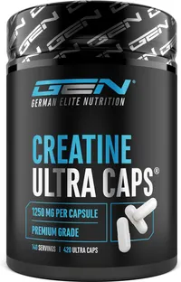 Un pot noir de créatine en gélules de la marque GEN German Elite Nutrition, avec l'inscription 'CREATINE ULTRA CAPS'. On peut lire '1250 MG PER CAPSULE' et '420 ULTRA CAPS'. Quelques gélules blanches sont visibles à côté du pot.