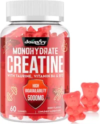Bouteille de créatine Joiavvy en gummies, de couleur rouge, avec deux gommes en forme d'oursons à côté. L'étiquette indique 'Créatine Monohydrate avec Taurine, Vitamine B6 & B12' et '5000mg'.